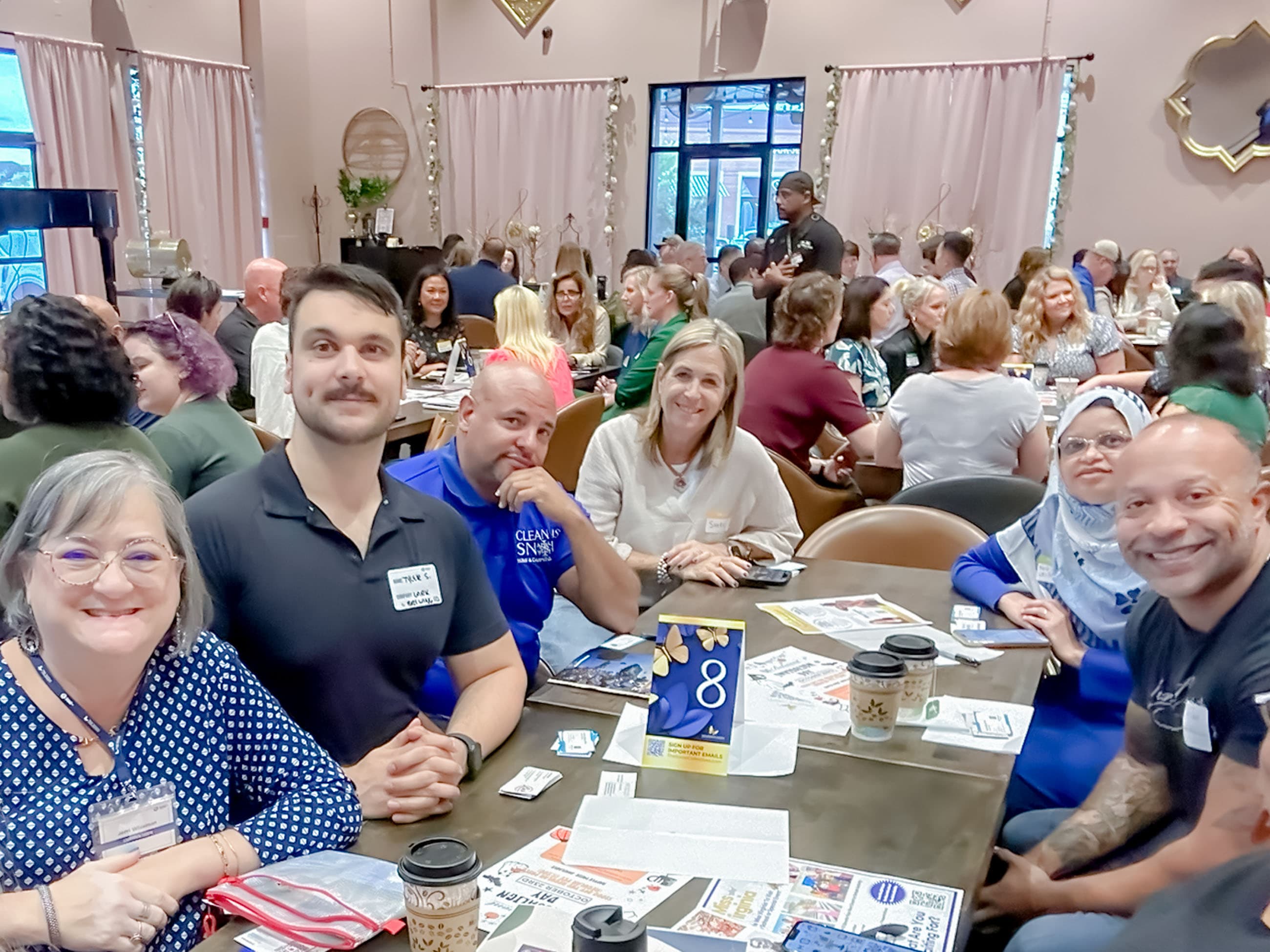 Smiling professionals networking at a Social Collectives event